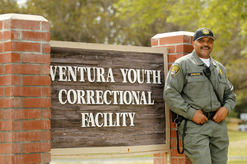Ron Jenkins stands next to a sign of the Ventura Youth Correctional Facility.