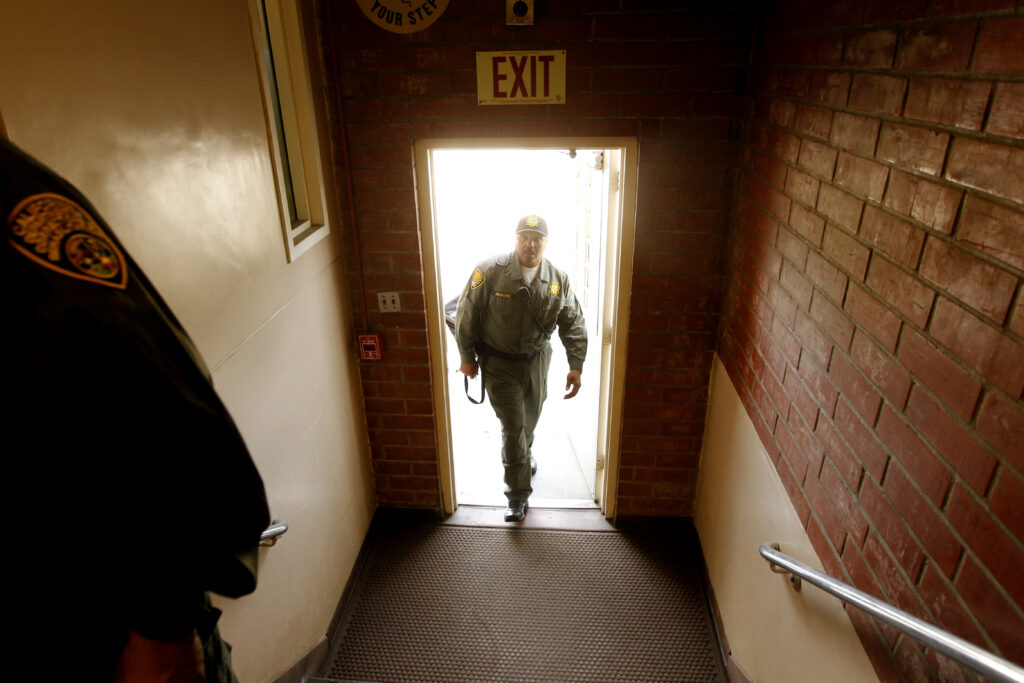 Ron Jenkins walks through a doorway into a corrections and juvenile facility.