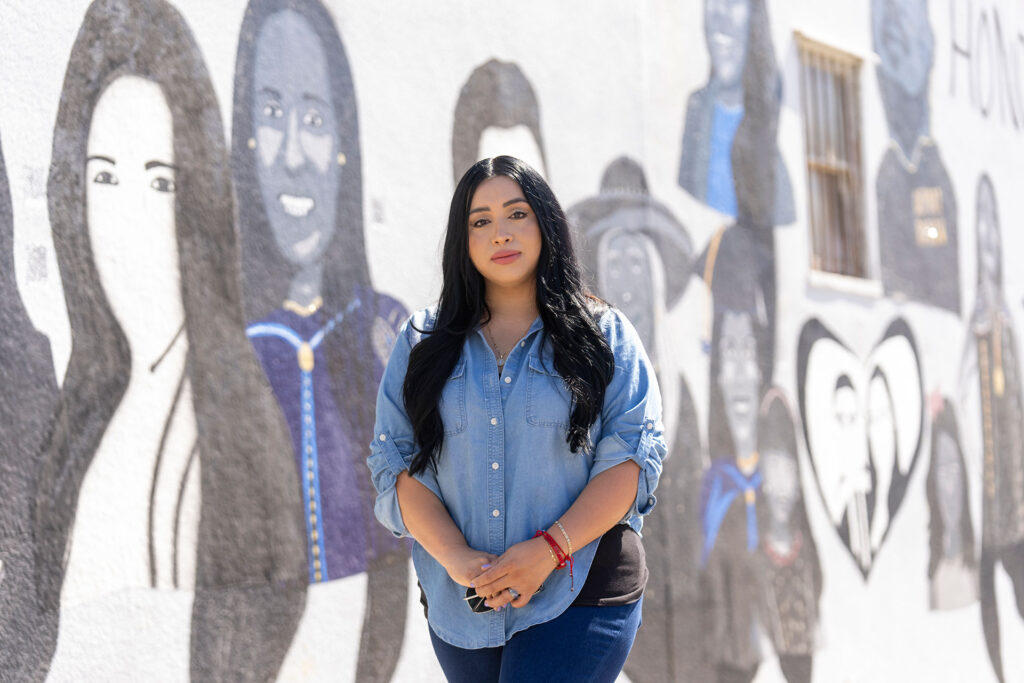 Dr. Lizbeth De La Cruz Santana stands in front of the mural in Central Fresno.