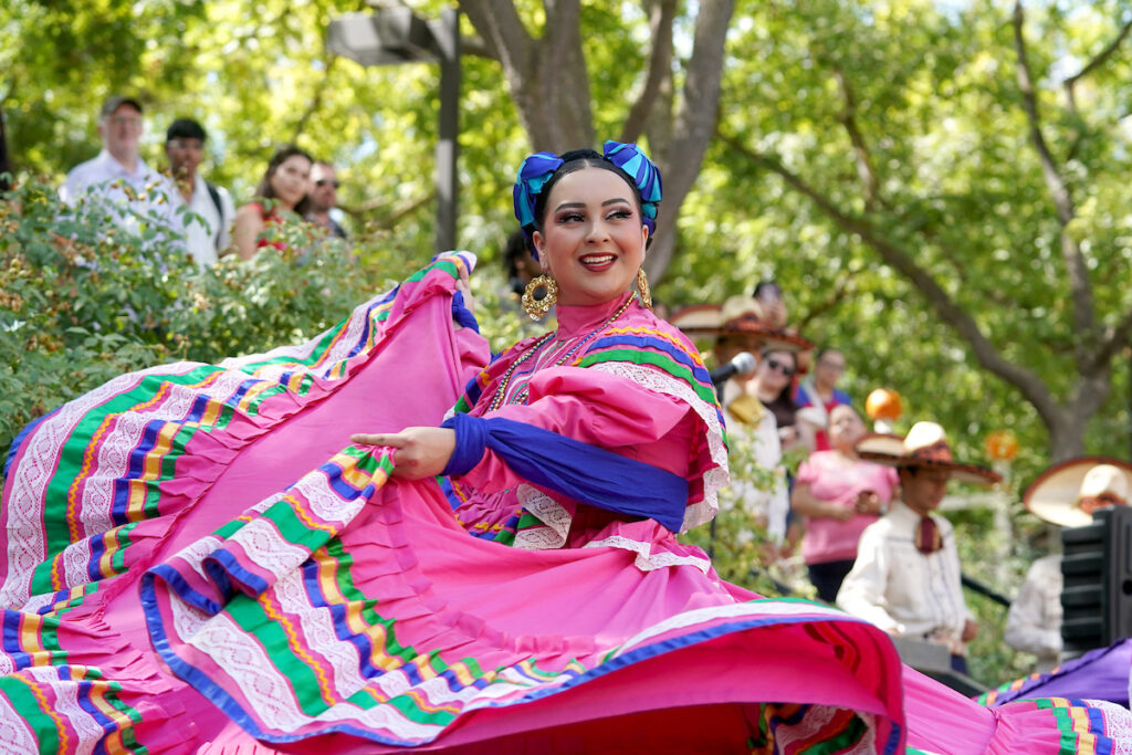 folklorico dancer with a crowd in the background
