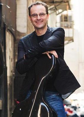 Thomas Landschoot leans on his cello case.