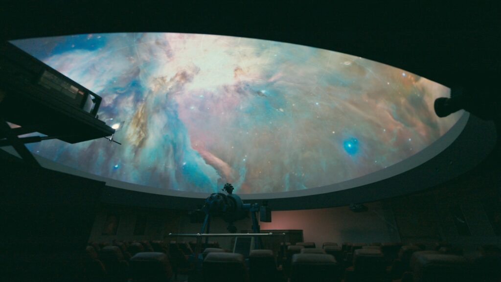 A colorful field of stars is projected on the dome of the Downing Planetarium
