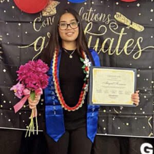 AANAPISI student Abbie Formoso shows a certificate she received at the end of her first year working with the program as a peer mentor. 
