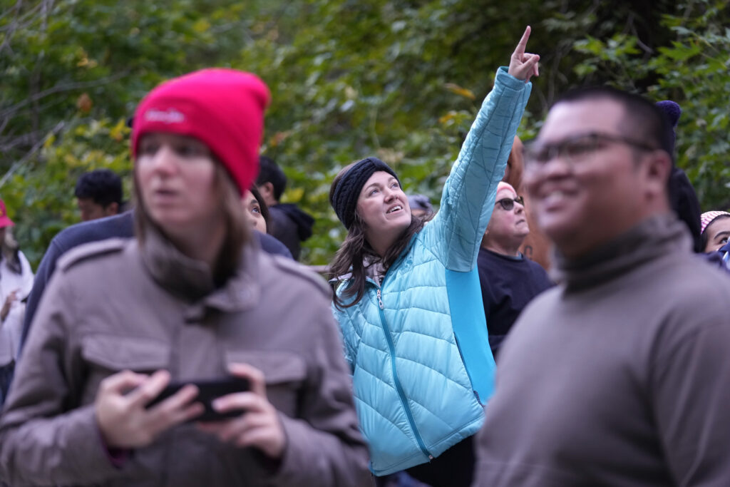 A student points at something in the distance