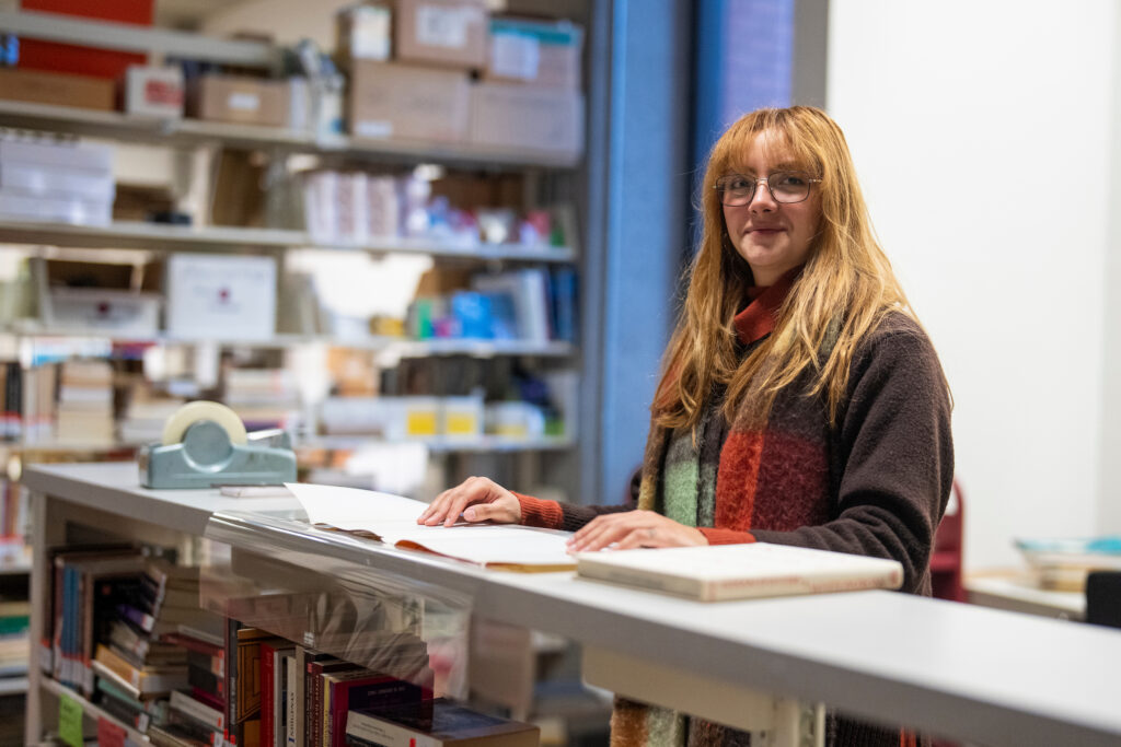 Alondra Muratalla Farías examines pre-Columbian and Mexican art books in the Fresno State Library.