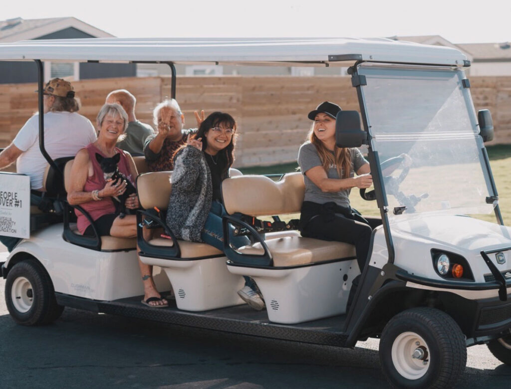 Folks on a cart at the Salt + Light community.