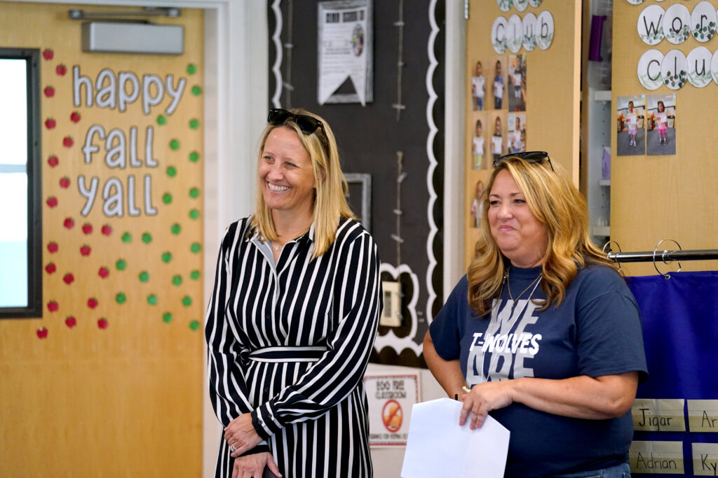 Dr. Corrine Folmer stands with a woman in a classroom.