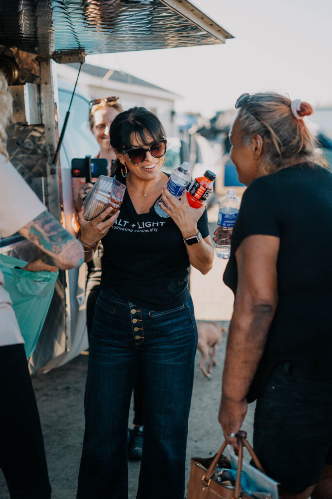 Adrianne Hillman hands out food at the food truck.