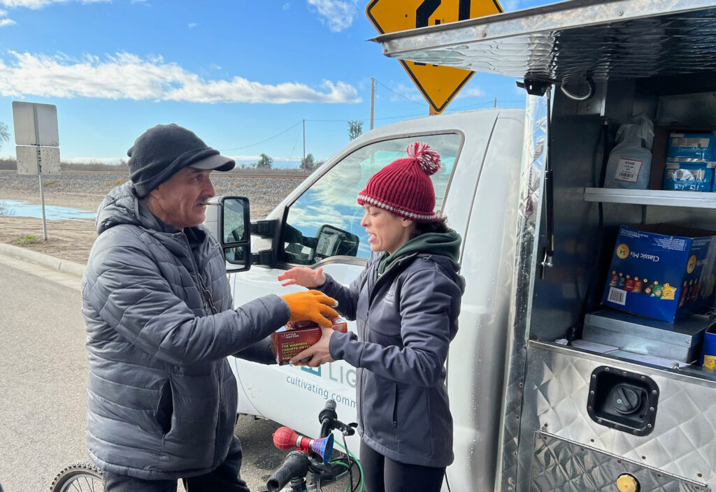 Adrianna Hillman hands out food from the food truck.