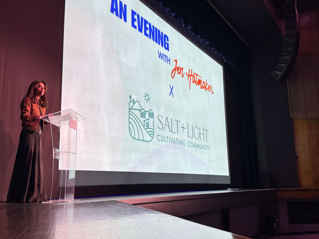 Adrianne Hillman stands at the podium at the LJ Williams Theater in Visalia to introduce author Jen Hatmaker.