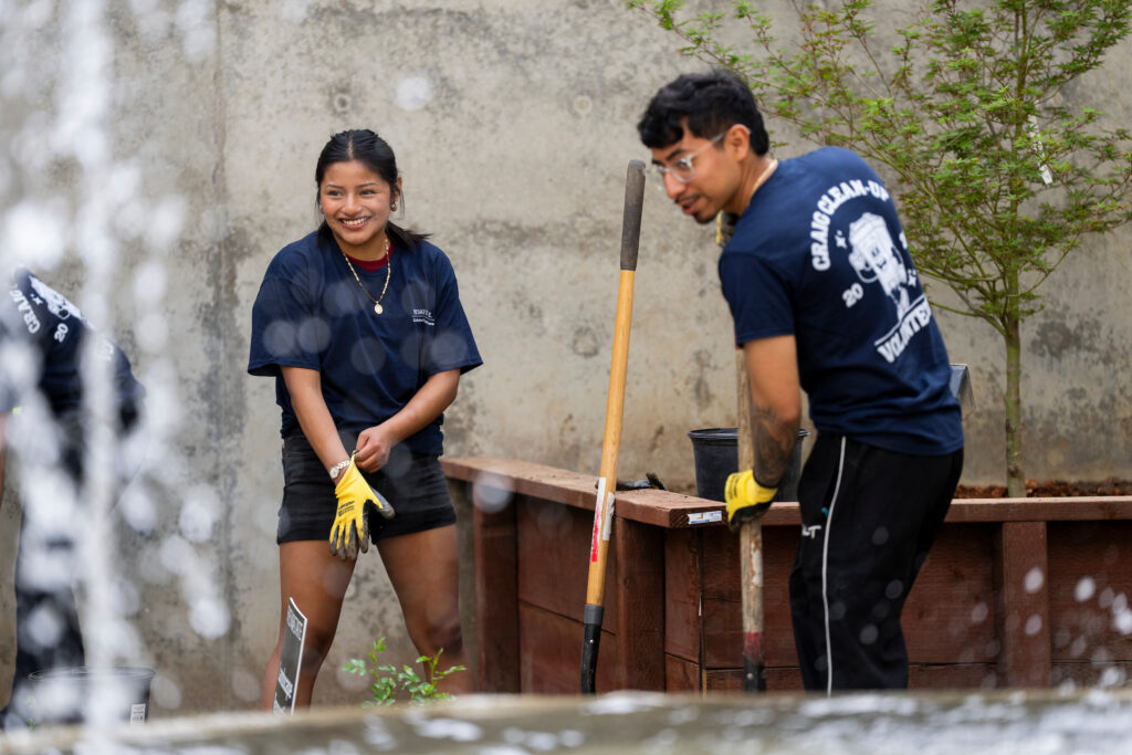 Students planting new vegetation at Peters Building fountain