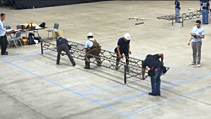 A group of students build a model steel bridge