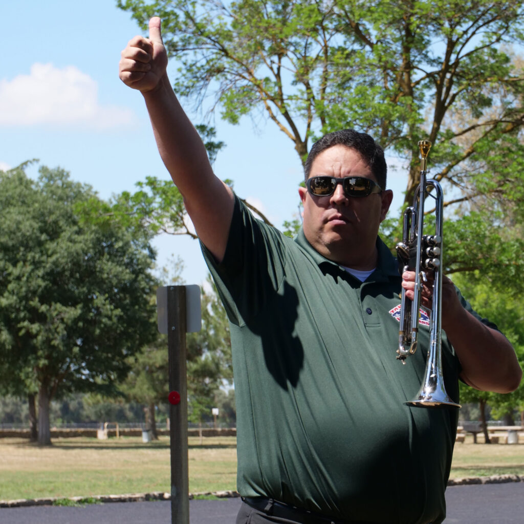 Brian Archuleta gives the thumbs up signal to another bugler.