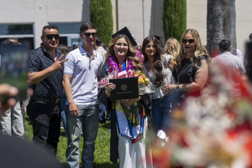 2026 Child and Family Science graduate Crystal Higuera with her family after the College of Social Sciences campus commencement ceremony on May 15, 2026.