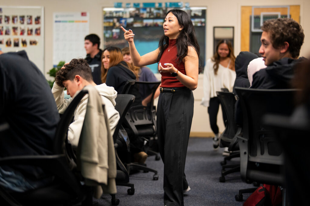 Chrizia Dela Rosa in the middle of the classroom surrounded by students.