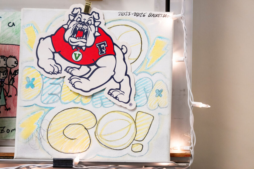 A Fresno State Bulldogs sticker is clipped to a piece of artwork in Chrizia Dela Rosa's classroom.