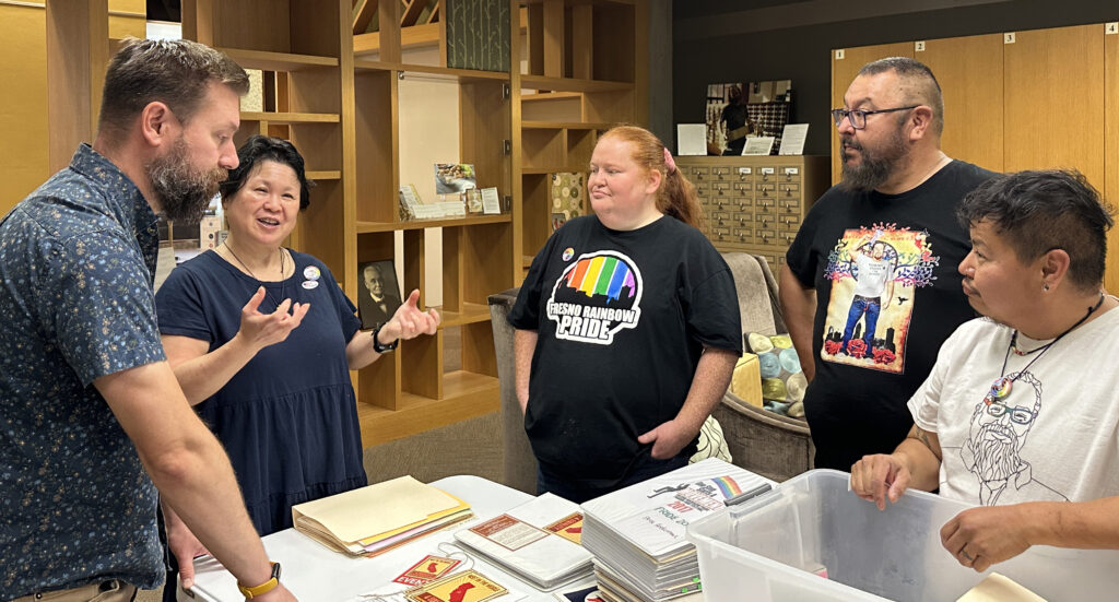 Library staff review materials submitted for the Rainbow Archive collection.