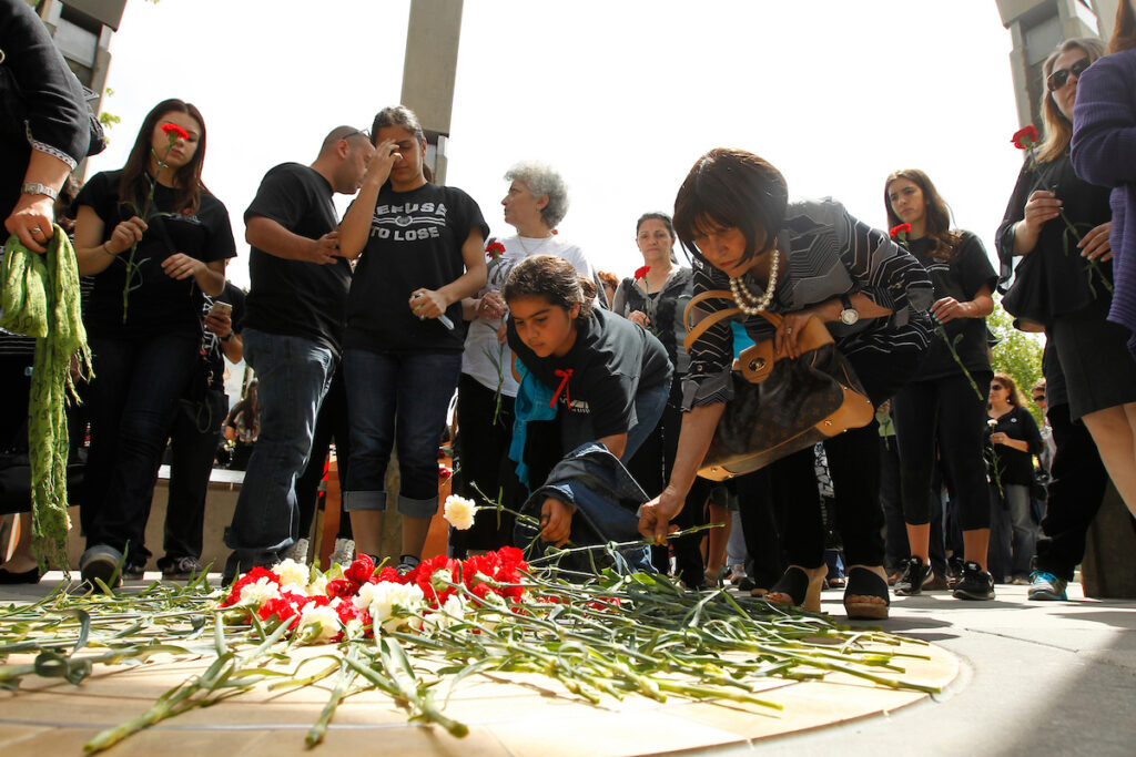 Community members lay flowers during an Armenian genocide commemoration ceremony.