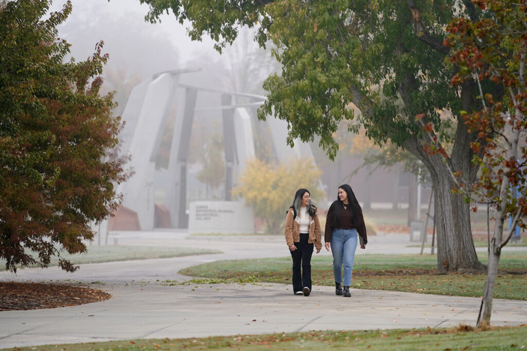 Students walk through campus with the Armenian Genocide Monument in the background.