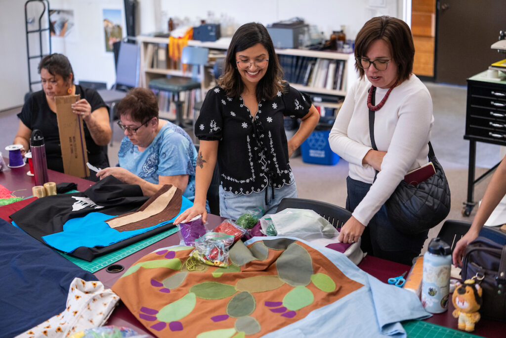 Several workshop members look at their shawls.