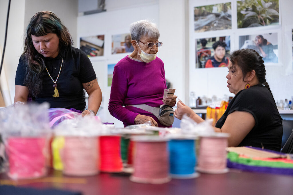 Corky Mills works with two workshop attendees.